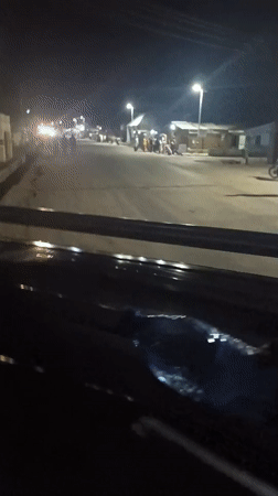 Evening street scene captured from moving vehicle in Wase