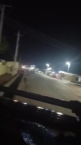 Evening street scene captured from moving vehicle in Wase
