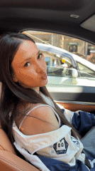Woman takes selfies with flowers in Yerevan car