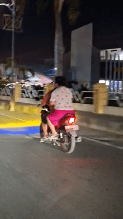 Couple spotted riding motorcycle in Lhokseumawe, Indonesia