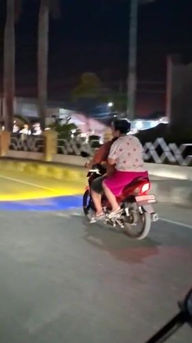 Couple spotted riding motorcycle in Lhokseumawe, Indonesia