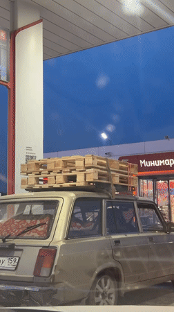Woman refuels car, takes selfies with lilacs at Perm gas station