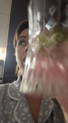 Woman holds glass in domestic setting in Лобаново