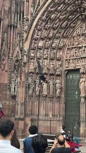 Acrobats perform outside Strasbourg Cathedral on a summer evening