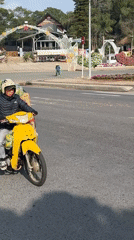 Moped rider transports vegetable cargo through Da Lat, Vietnam