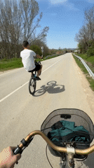 Cyclist performs wheelie on road in Djulunitsa, Bulgaria