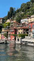 Tourist enjoys gelato amid colorful buildings in Varenna, Italy