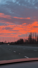 Motorist captures colorful dawn sky on UK highway