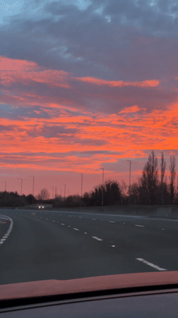 Motorist captures colorful dawn sky on UK highway
