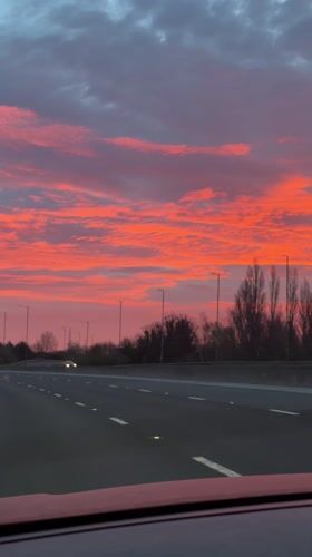 Motorist captures colorful dawn sky on UK highway