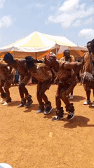 Traditional dance and political campaigning mix at an outdoor event