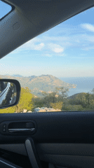 Passenger captures scenic roadside view from moving vehicle
