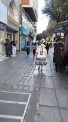 Pedestrians walk along La Paz street in evening hours