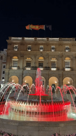 Illuminated fountain lights up a Castelló de la Plana square at night