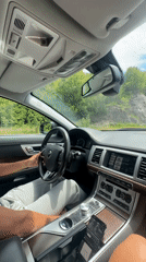 Couple drives through Montenegro hills, woman gestures from passenger seat