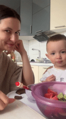 Mother and child share lunch in Odintsovo kitchen