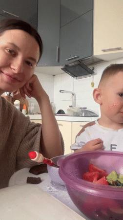 Mother and child share lunch in Odintsovo kitchen