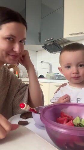 Mother and child share lunch in Odintsovo kitchen