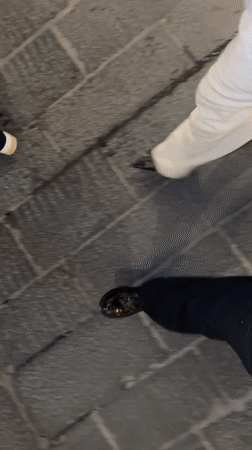 Pedestrians walk stone streets in Taormina, Italy