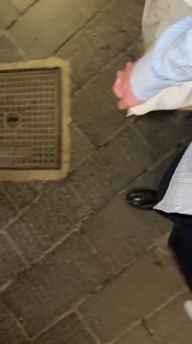 Pedestrians walk stone streets in Taormina, Italy