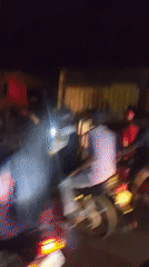 Nighttime street gathering and fish sighting recorded by witnesses