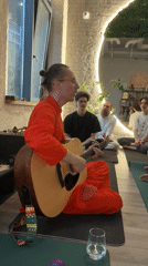 Man plays acoustic guitar on yoga mat in Moscow