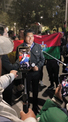 Nighttime protest crowds gather near government buildings in La Paz