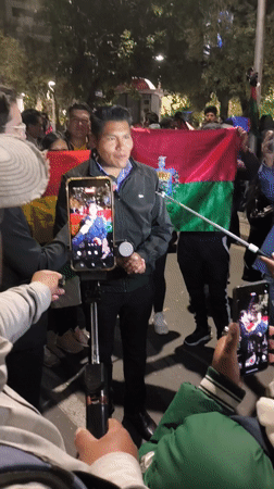 Nighttime protest crowds gather near government buildings in La Paz