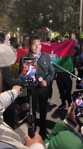 Nighttime protest crowds gather near government buildings in La Paz
