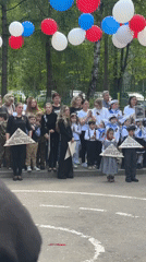 Children hold triangular objects at outdoor gathering in Shulgino