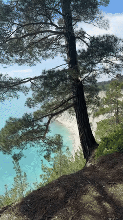Woman films selfies at scenic clifftop in Dzhankhot, Russia