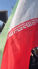 Demonstration with chador-clad women holding Iranian flags in Tehran