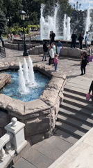 Ornate mosaic fountains draw a crowd in a sunny city park