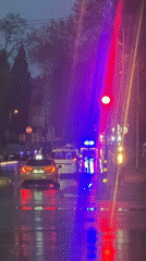 Wet streets reflect lights during evening in Varna, Bulgaria