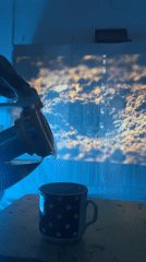 Dark liquid poured into mug under blue lights in Ukraine