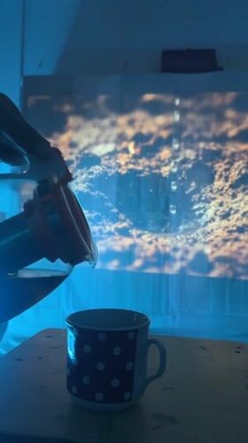Dark liquid poured into mug under blue lights in Ukraine