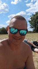 Sunny beach moment with guitar reflections in mirrored shades