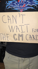 Person displays handmade "CM CARD" anticipation sign in Bulgaria