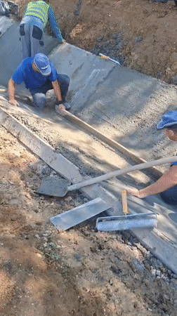 Concrete trench work underway on a Hîncești roadside