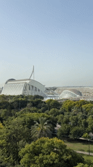 City of Arts and Sciences framed by green parkland on a sunny morning