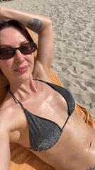 Woman sunbathes on Vietnamese beach during early morning hours