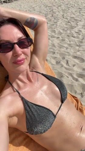 Woman sunbathes on Vietnamese beach during early morning hours