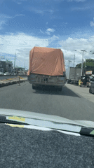 Morning traffic flows beneath railway overpass in Panabo