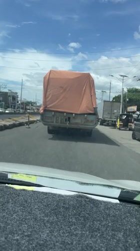 Morning traffic flows beneath railway overpass in Panabo