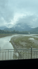 River valley view documented in cloudy Damauli, Nepal