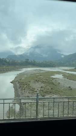 River valley view documented in cloudy Damauli, Nepal