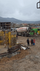 Construction crew supervises cement mixer operations in Markovo