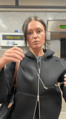 Woman waits at London Underground elevator Thursday morning