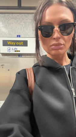Woman waits at London Underground elevator Thursday morning