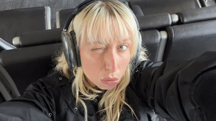 Woman waits in airport seating area in Los Angeles